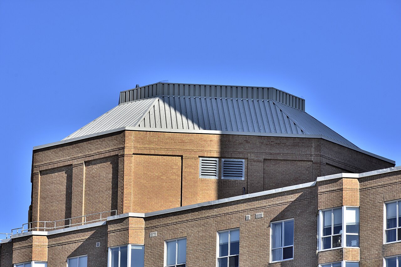 Mechanical penthouse at the top of a high-rise condominium in Toronto under a blue sky.